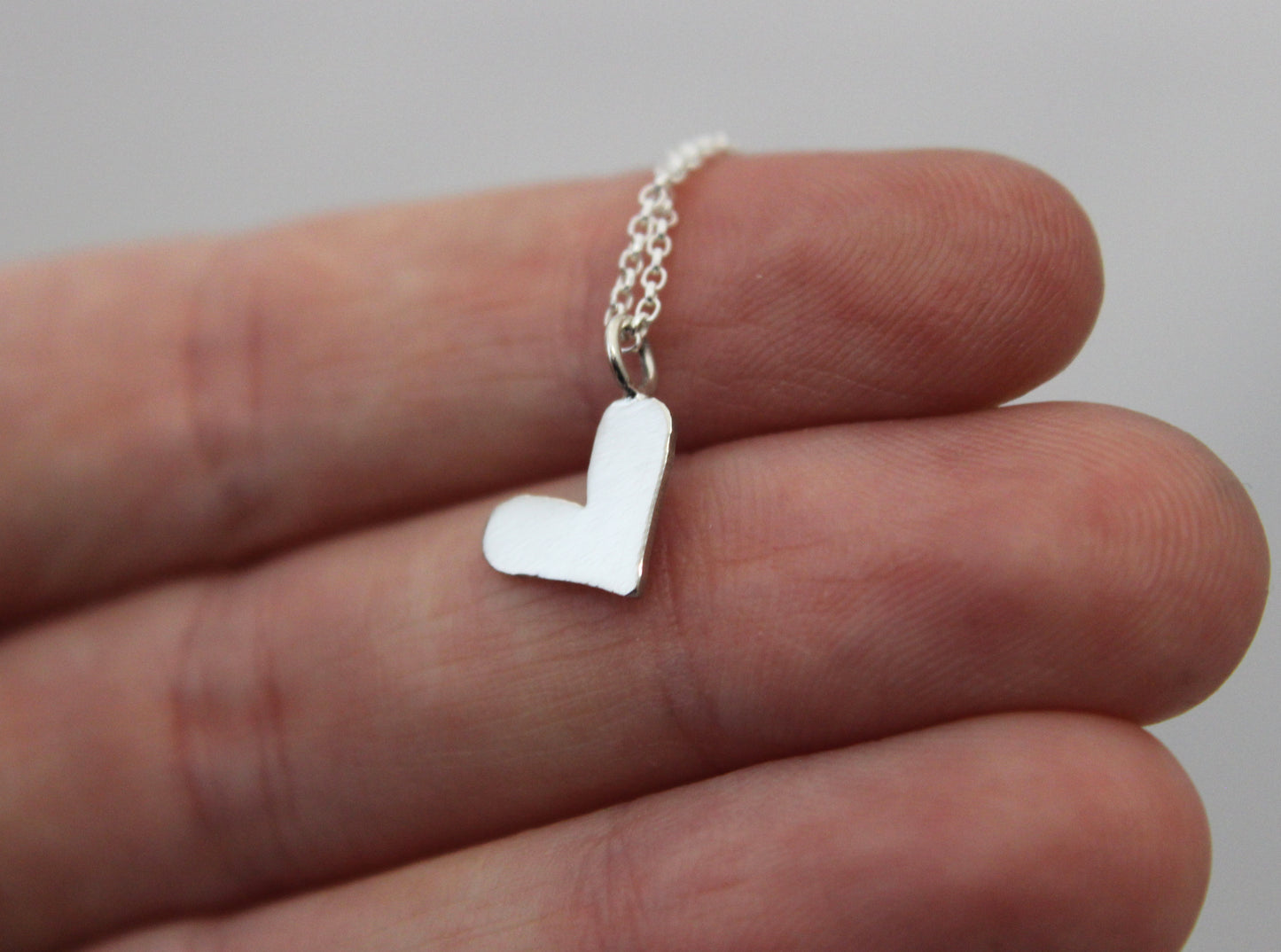 Song bird rear view mirror puzzle charm, and sterling silver heart necklace