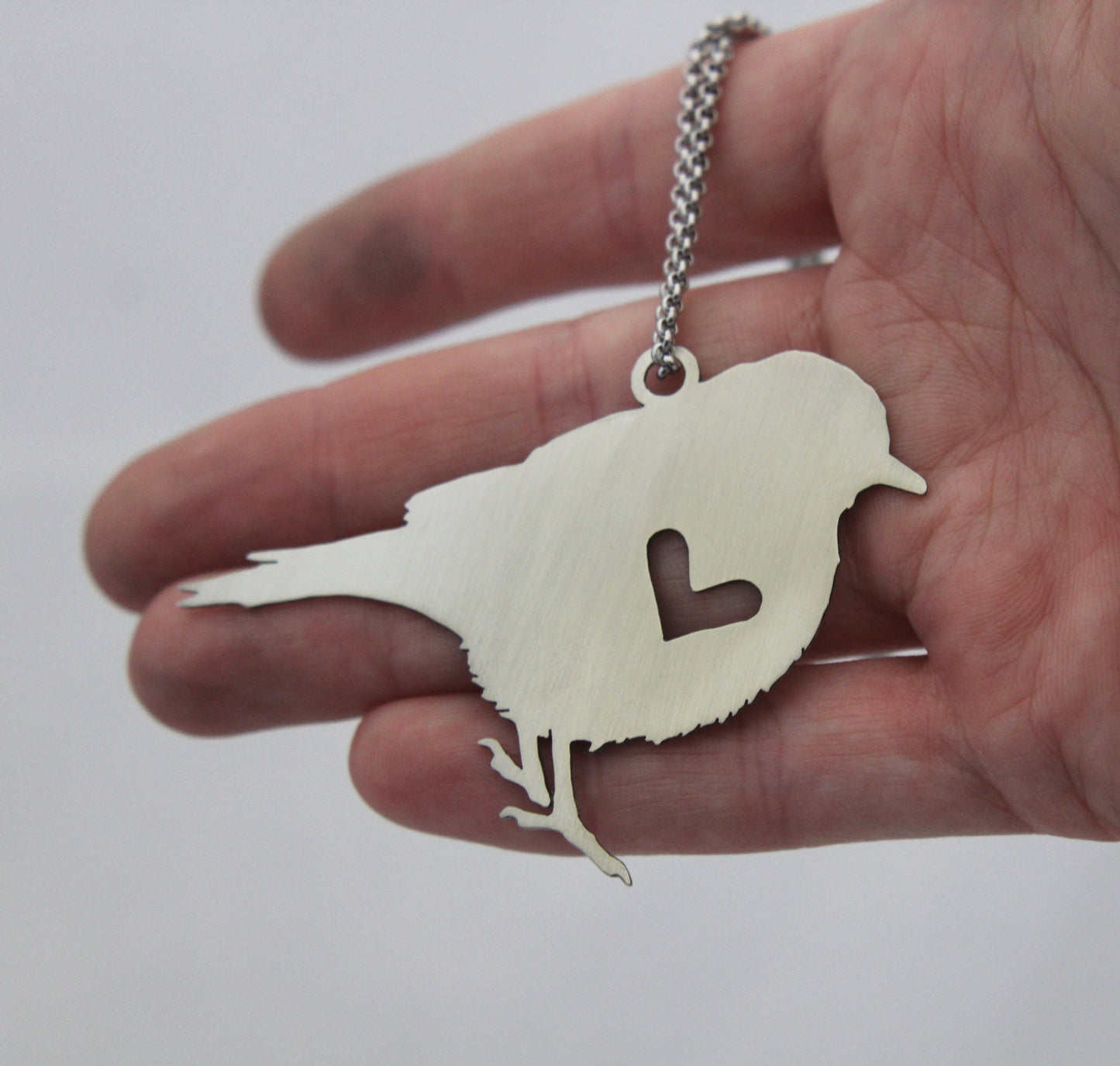 Song bird rear view mirror puzzle charm, and sterling silver heart necklace